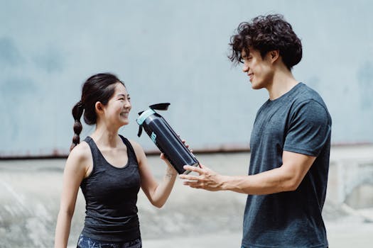 person drinking water during exercise