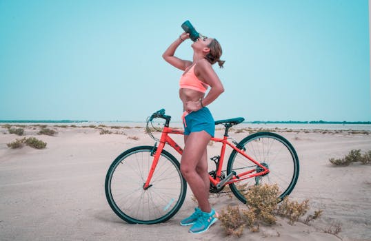 woman drinking water while exercising